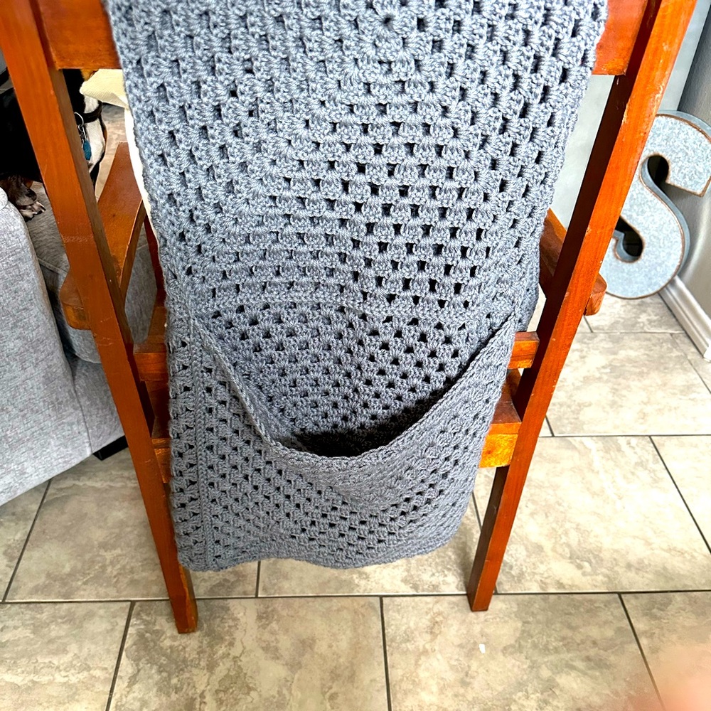 Grey crochet blanket with pocket